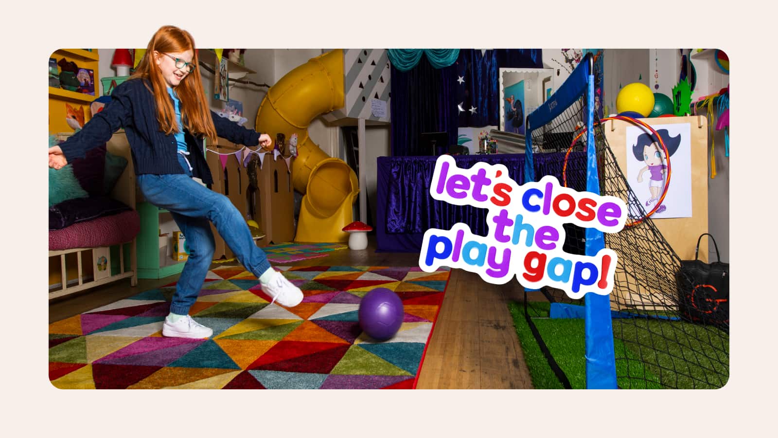 Girl playing football in playroom
