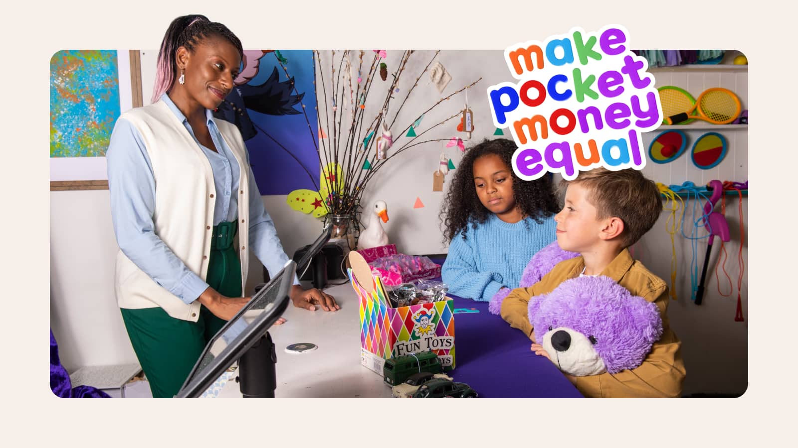 Two children holding teddy in front of cashier