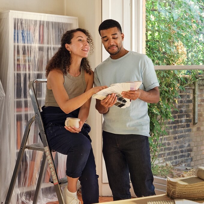 image shows a couple in the middle of a house renovation