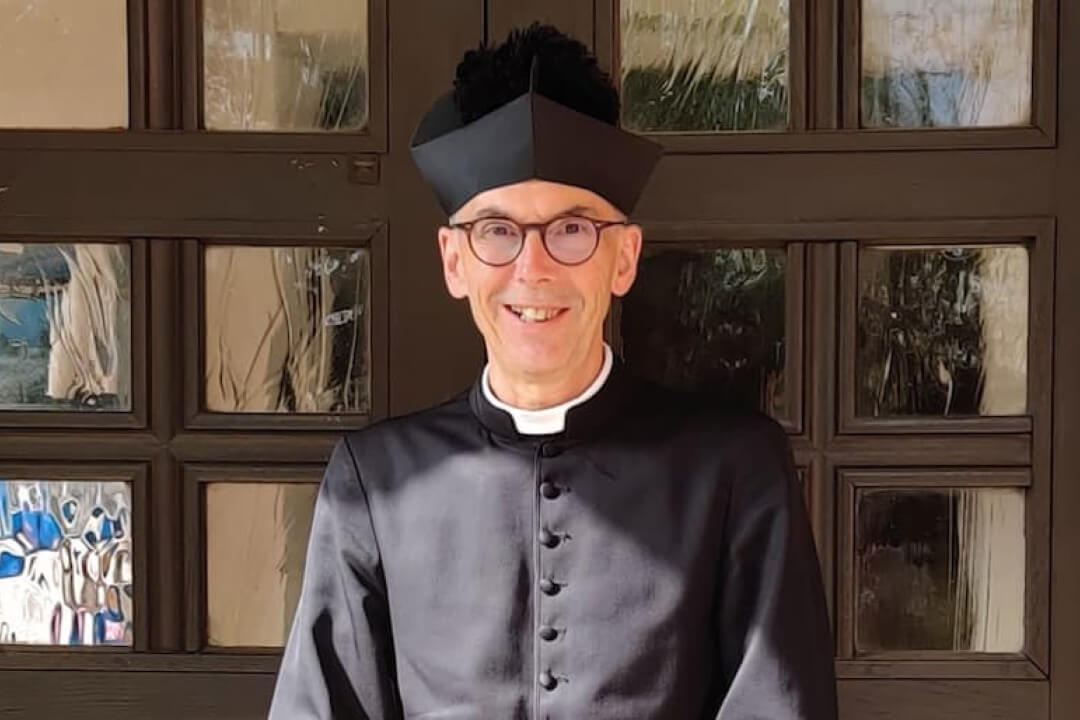 Father Stephen outside church doors