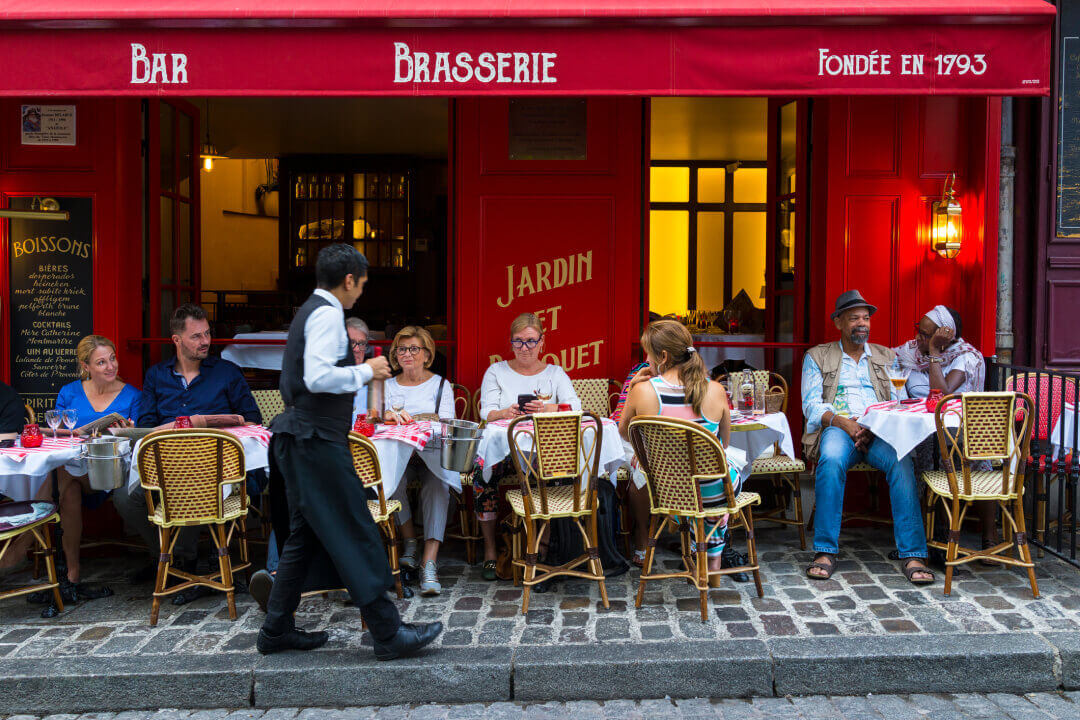 Parisian Brasserie with people eating outside on the pavement