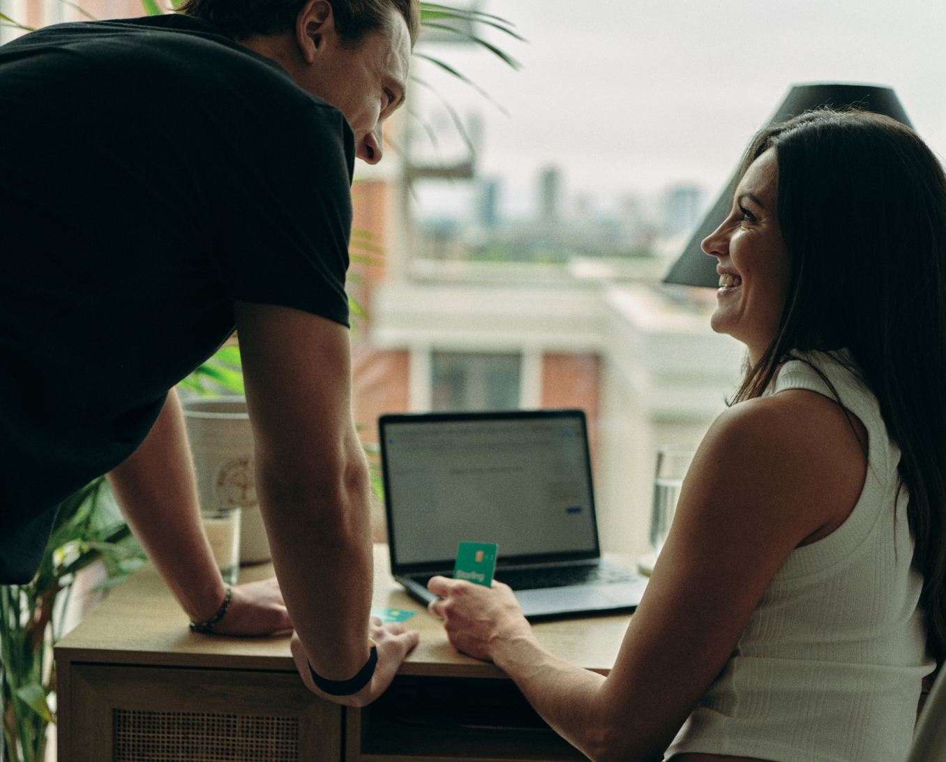 A couple planning a budget with 2 Starling bank Joint account cards on the table