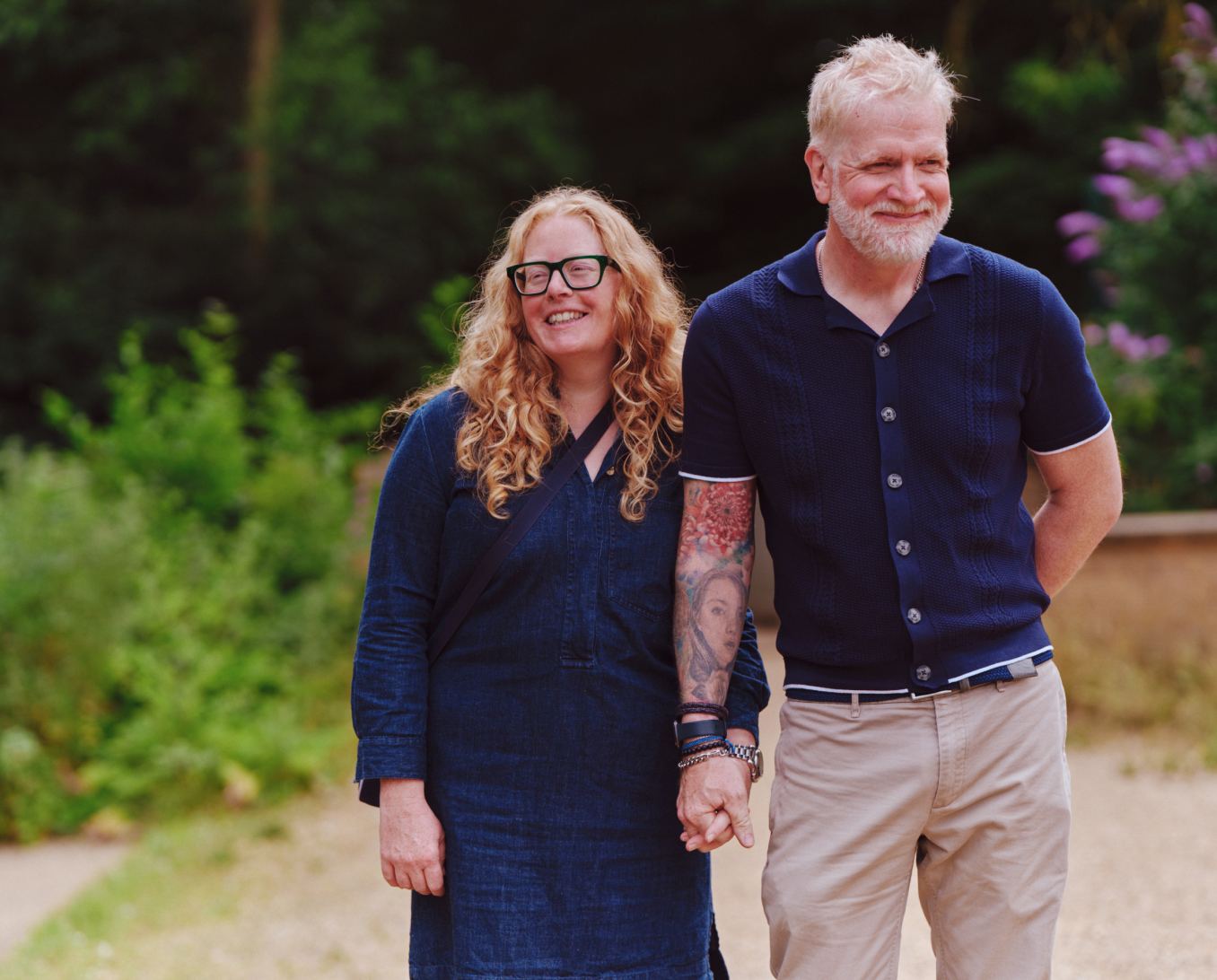 A couple smiling holding hands