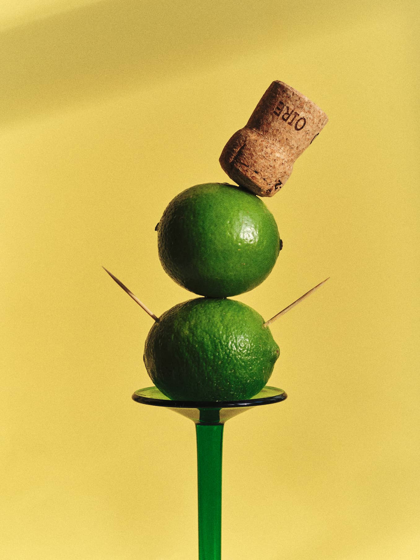 Lime and corkscrew balancing on a martini glass