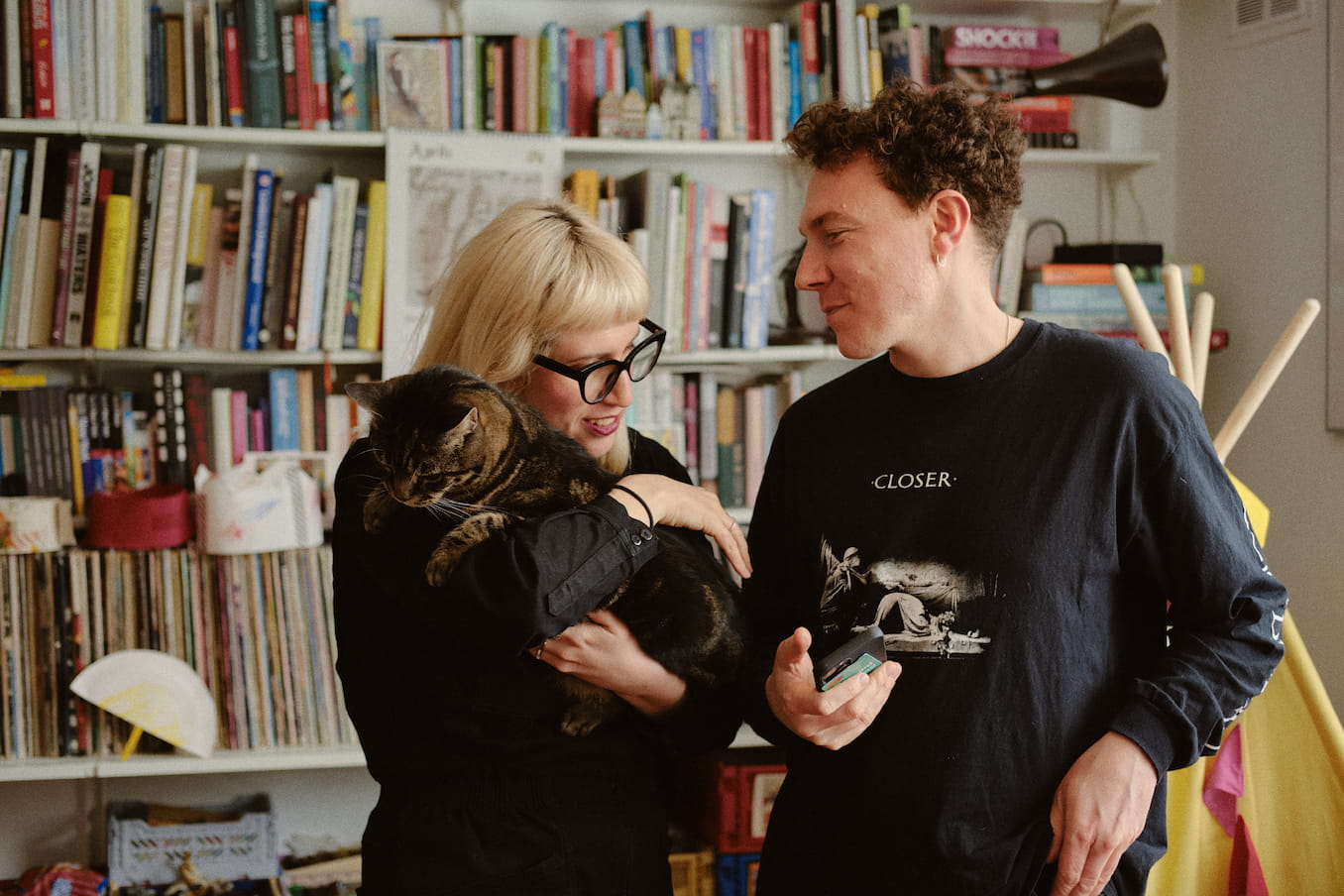 couple-with-cat-bookshelf-behind