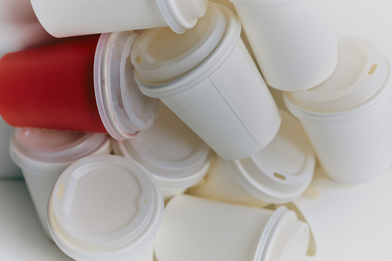 Photograph of a collection of takeaway coffee cups, some of which have been used.