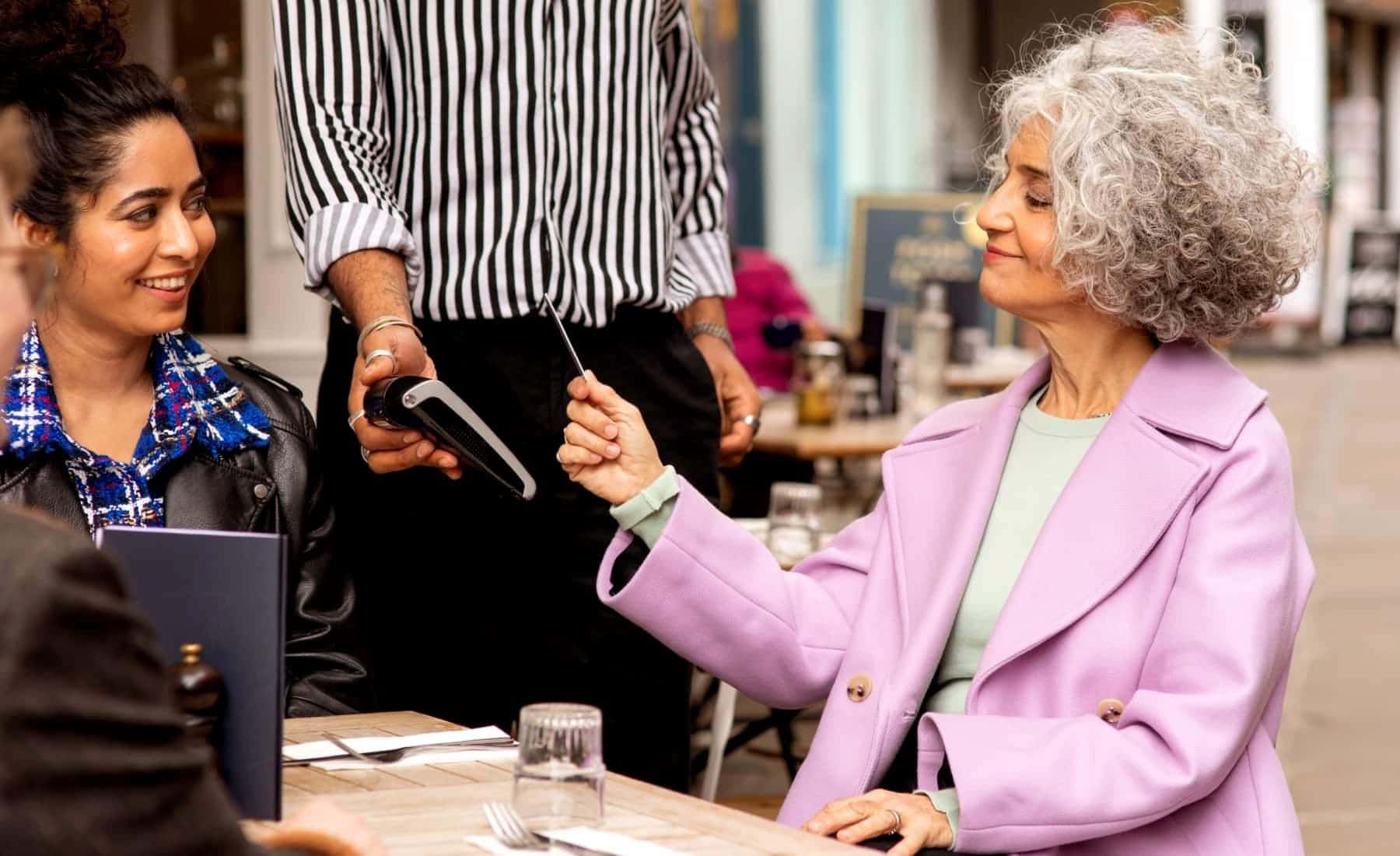 Lady in pink coat using contactless payment