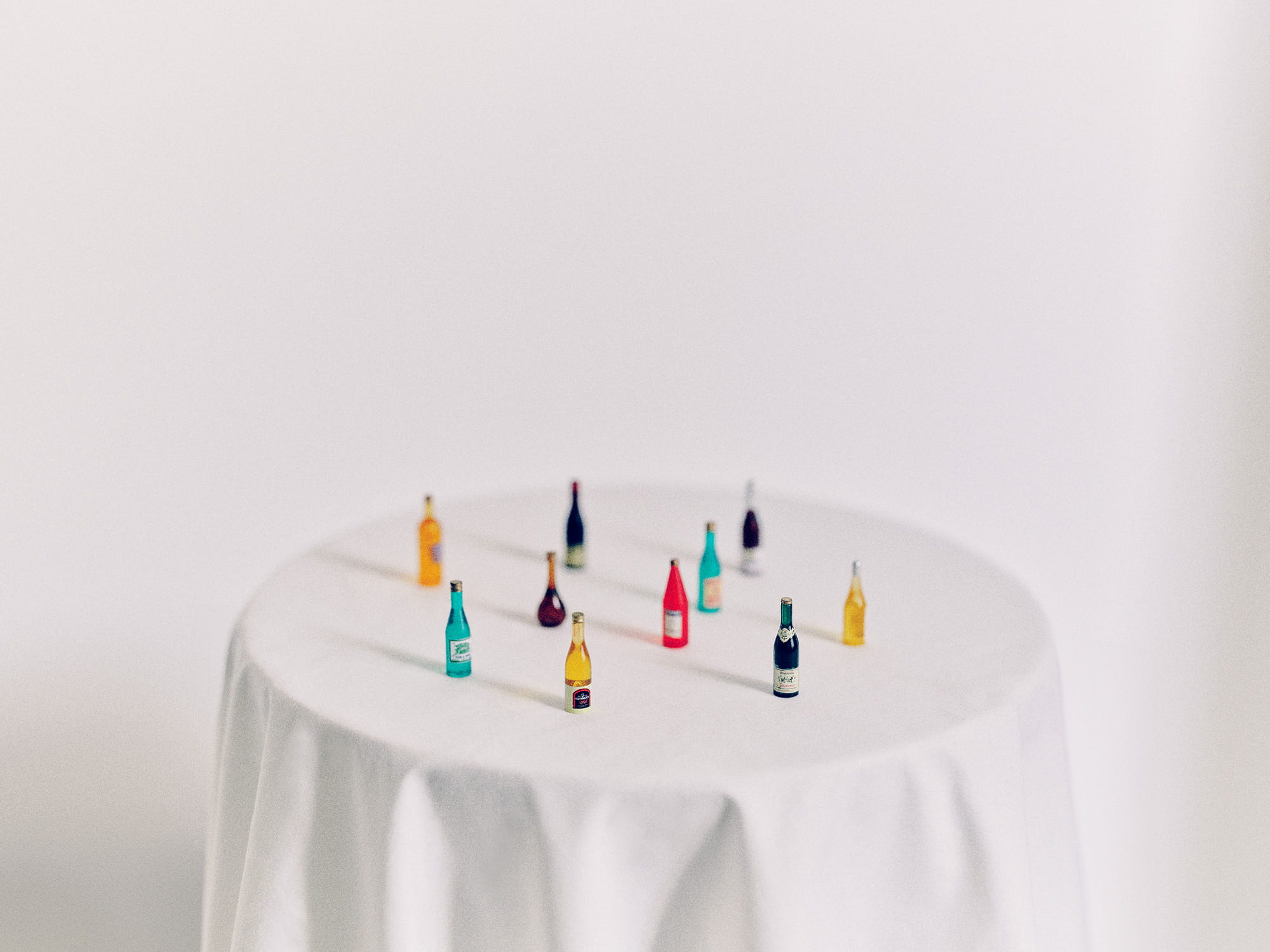 Miniature alcohol bottles on a white tablecloth