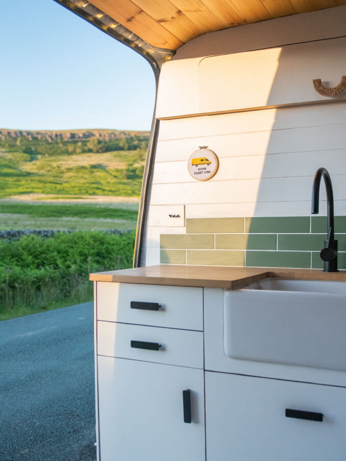 camper van kitchen with a view on mountains