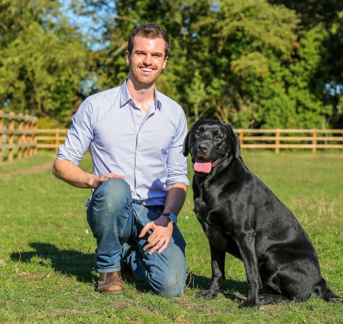 Dr Laurie Barrow, co-founder of The Woodbridge Vets with a black dog