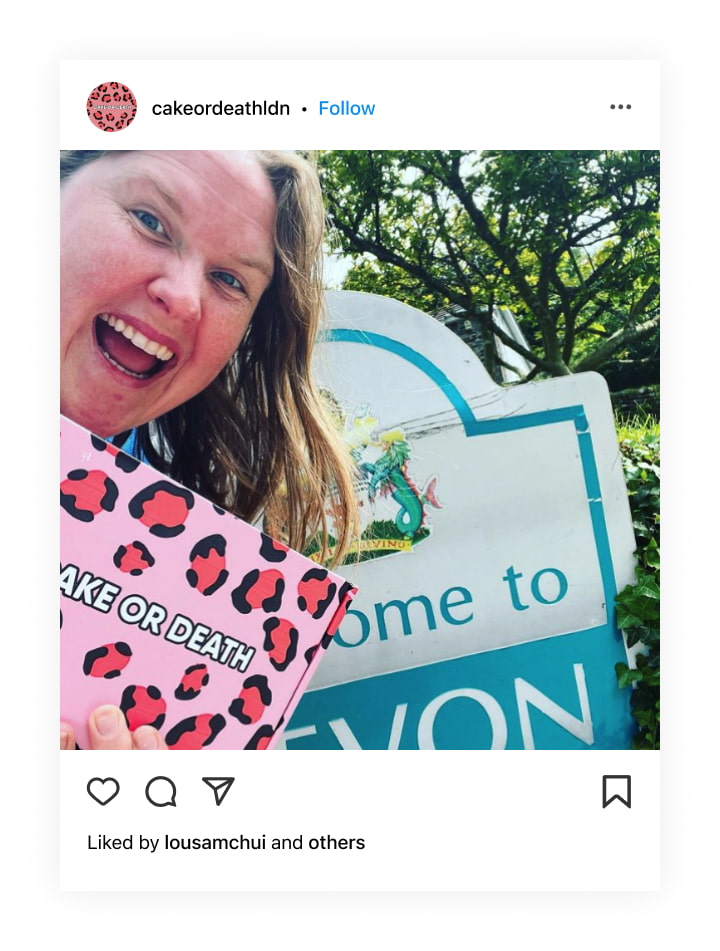 A woman holding a box with the Cake or Death design on it