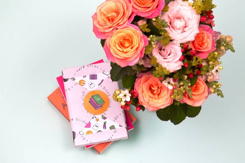 A wrapped book, and a selection of flowers.