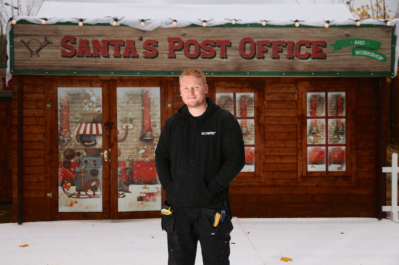 Oliver stands infront of Santa’s Post Office
