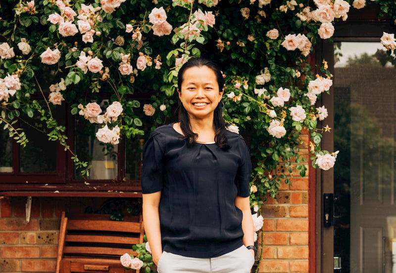 Christina Hsieh stood in front of flowers smiling.