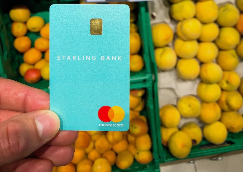 A teal Starling card at a fruit stand