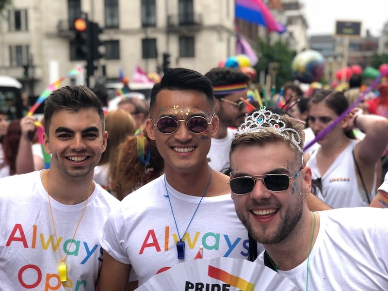 Nate, Wilson, and Thomas smile at Pride