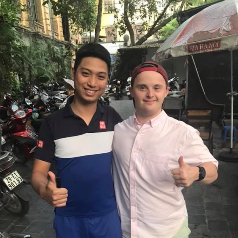 Alex smiles with a friend in Hanoi