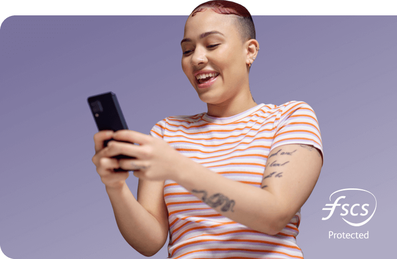 Happy lady in a striped shirt holding mobile